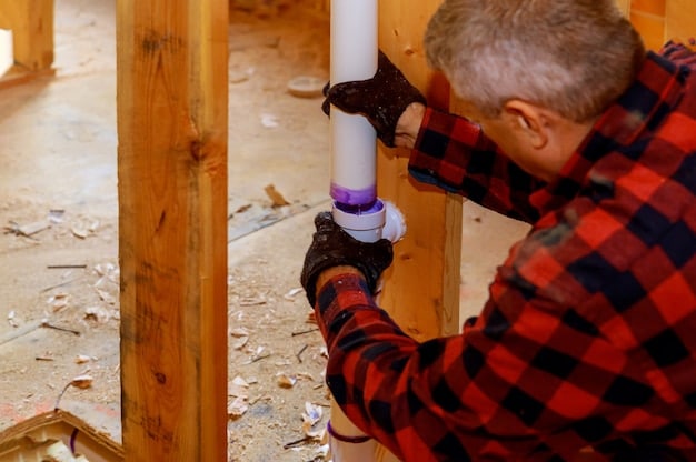 A close-up shot of a person insulating water pipes with foam insulation tubes in a basement, highlighting the importance of preventing frozen pipes.
