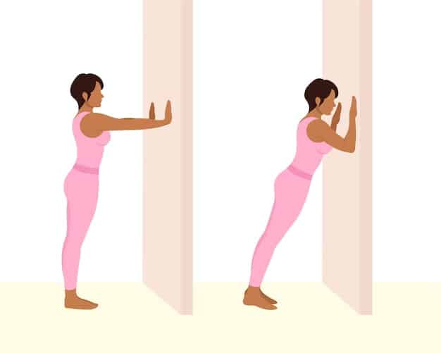 A person performing a doorway chest stretch with proper form.