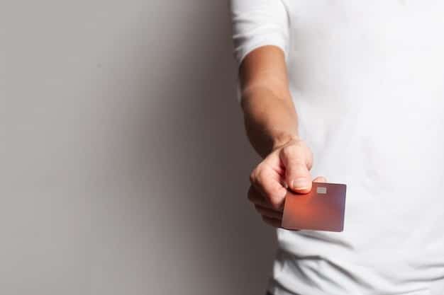 A close-up of a hand holding an insurance card, emphasizing the importance of understanding insurance coverage. The background is blurred to focus on the card and the hand.