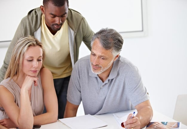 A happy middle-income family sitting around a table, reviewing their tax returns and discussing their finances.