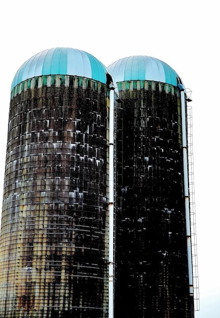 A split image showing two factories. On one side, a modern, high-tech American factory, and on the other, a factory in another country with lower wages and less automation, symbolizing the competitive pressures of trade agreements.