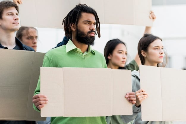 A diverse group of American workers in various industries, holding signs advocating for fair wages and safe working conditions.