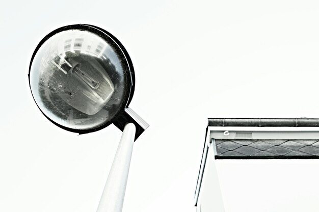 A conceptual image representing media literacy, showing a magnifying glass examining fragments of news articles and social media posts, symbolizing the critical evaluation of information sources and the ability to discern credible journalism from misinformation.