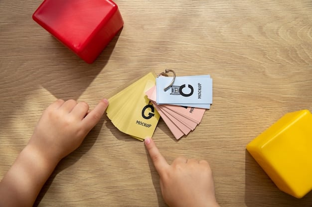 A child's hand pointing at a small label on a toy, with the label showing a series of alphanumeric characters representing a model number or batch code. The image has a warm, soft focus.