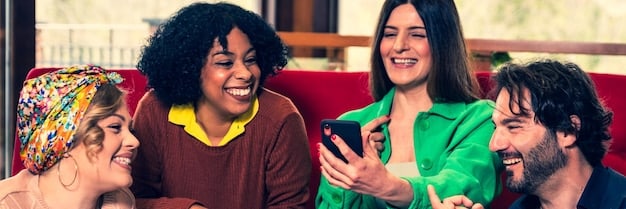 A diverse group of young adults laughing while looking at a smartphone, where a viral 