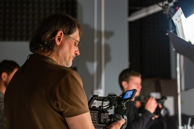A close-up shot of a director looking intently at a monitor on a film set, surrounded by crew and equipment, suggesting the meticulous nature of film production.