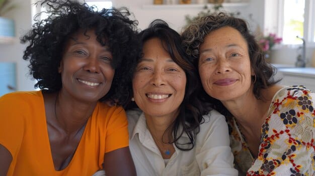 A diverse group of women, of various ages and ethnicities, smiling and engaging with a healthcare provider during a community health fair focused on preventive care. Colorful banners promoting breast health are visible in the background.