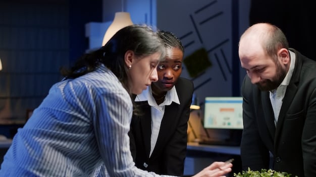 A diverse team of US business professionals collaborating around a digital dashboard, visualizing real-time supply chain data and discussing mitigation strategies, emphasizing data-driven decision-making and teamwork.