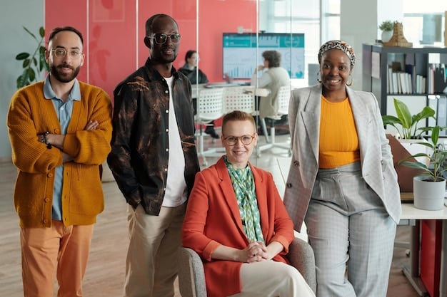 A diverse group of employees collaborating and smiling in a modern, inclusive office, reflecting talent retention and a positive work environment.