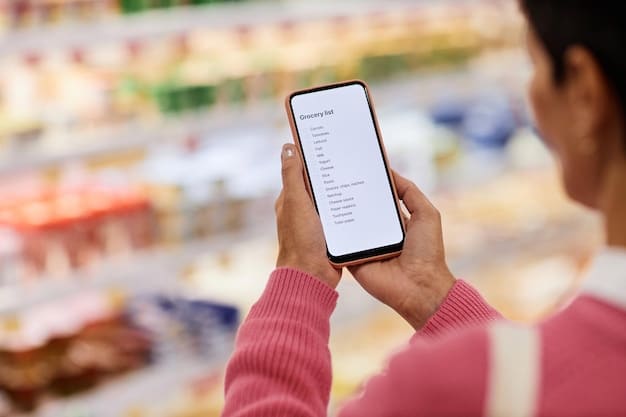 A person using a smartphone to compare prices of grocery items in a supermarket aisle. The smartphone screen displays various online deals and discounts, indicating smart shopping habits.