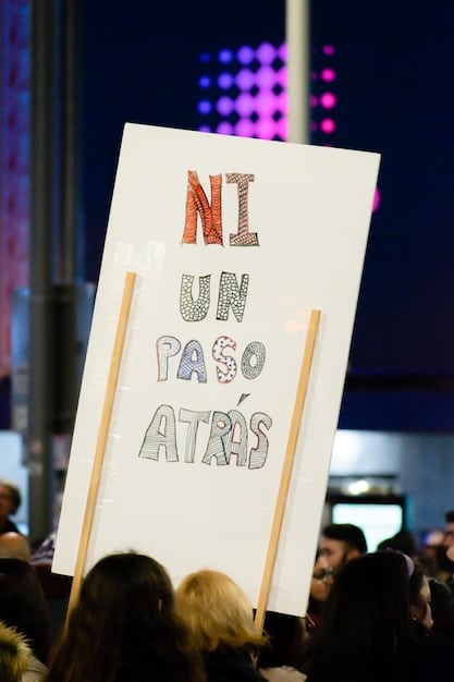 A fan holding up a sign at a concert with the words 