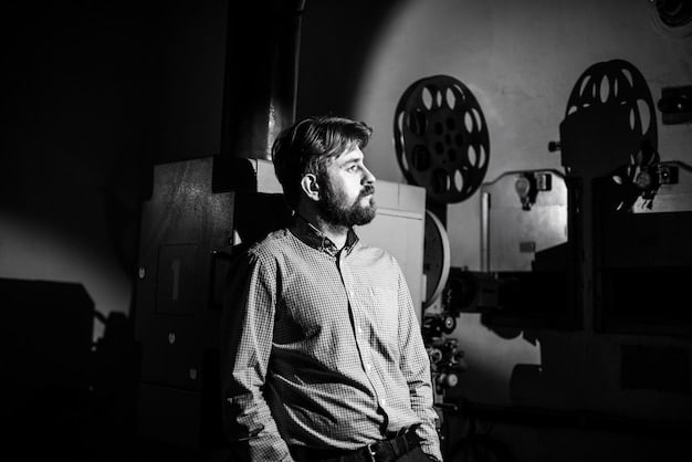A black and white photograph of a film director passionately explaining a scene to their cast and crew on an independent film set. The set is small and intimate, with a sense of collaboration and creativity palpable in the air. This captures the spirit of independent filmmaking, where passion and dedication often outweigh budgetary constraints.
