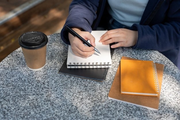 A person is shown writing something using a pen and notepad. Beside the notebook and pen is a cup of green tee which displays a sense of healthiness and a study environment suitable to Boost Your Brainpower: 5 Foods That Can Improve Memory and Focus.