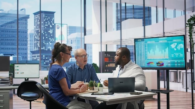 A diverse group of professionals collaborating in a modern, tech-enabled office space, surrounded by monitors displaying data analytics and design concepts, symbolizing innovation and teamwork.