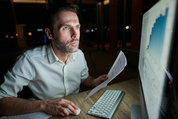 A person looking thoughtfully at a computer screen displaying complex tax forms and financial charts, representing the detailed analysis required for tax preparation.